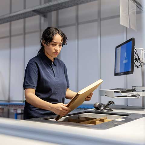 Picker scans package at distribution center